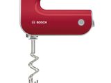 red electric hand mixer on a white background with a bottle opener