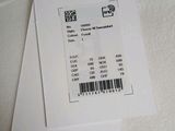 a receipt sitting on top of a piece of paper