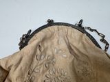 a purse that has been embroidered with flowers on it