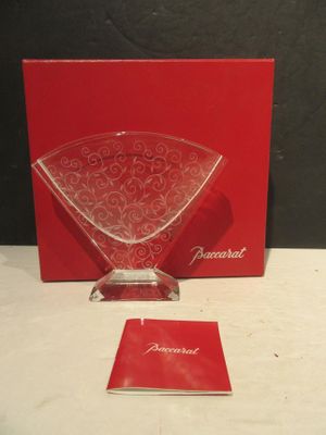 a red box that has a glass vase on it