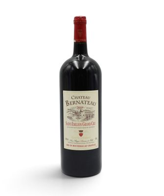 bottle of red wine with a red cap on a white background