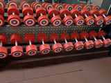 a lot of dumbs on a rack in the gym