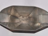 a silver tray on a white surface with a white background