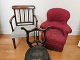 two chairs and a foot stool in the corner of a room