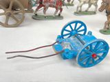 many toy figurines of horses and wagons on a table