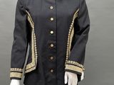 a mannequin wearing a black and gold jacket with gold buttons