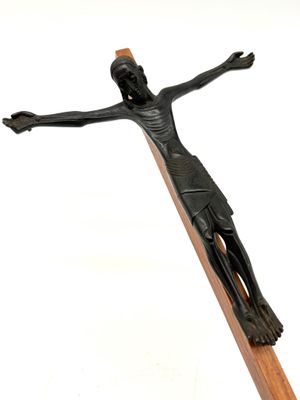 a statue of a man on a cross on a white background