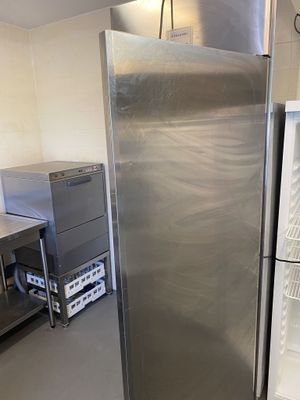 stainless steel refrigerator in a commercial kitchen with stainless steel counter tops
