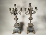 pair of antique silver candelabs on marble pedestals