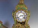 two clocks sitting next to each other on a table