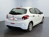 the back of a white car is parked in a room