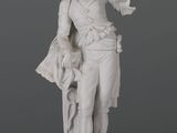 statue d'un homme portant un chapeau et un sac sur l'épaule