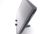 a tablet computer sitting on a stand on a white surface