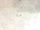 a close up view of a metal plate with a hole in it