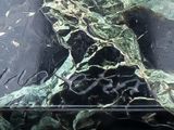 a close up of a black and white marble clock