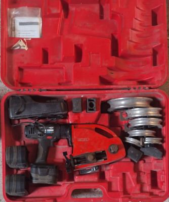 a red tool box with tools in it sitting on the floor