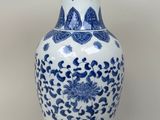 a blue and white vase sitting on a table