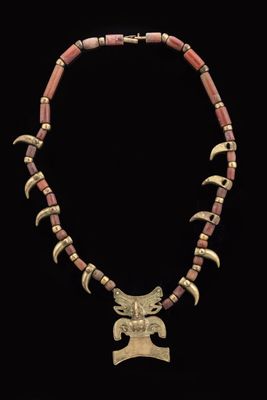 an image of a necklace with horns and beads on a black background