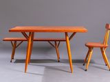 two chairs and a table in a room with a gray wall