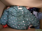 a cardboard box with clothes in it and a jacket in it