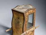 a small wooden box with a mirror on it