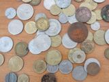 a pile of coins on a table with a coin in the middle of it