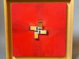 red and gold cross in a wooden frame on a gray background