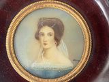 a miniature picture of a woman in a blue dress