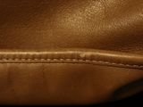 the inside of a brown leather purse with a zipper on it