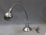 a silver lamp that is on a table