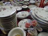 many plates and bowls that are on a table