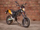 a motorcycle that is parked in front of a brick wall