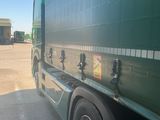 a green truck that is parked in the parking lot