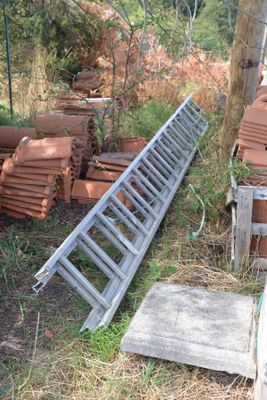 a pile of bricks sitting on the ground next to a fence