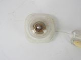 a light that is on a white surface with a cord