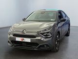 the front of a grey citrole parked in a large room