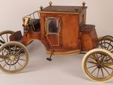 a small wooden horse drawn carriage on a white background