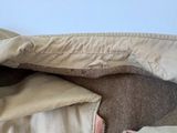 a cat that is laying on a bed under a blanket