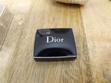 a picture of a dior ashtray on a wooden table