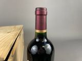 a bottle of wine sitting next to a wooden box