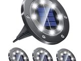 a close up of four solar powered lights on a white background