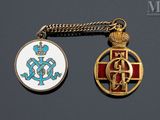 two medals that are on a chain on a table