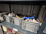 a metal shelf with a bunch of tools on top of it