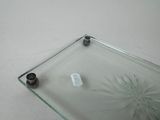 a glass shelf with a glass plate on it