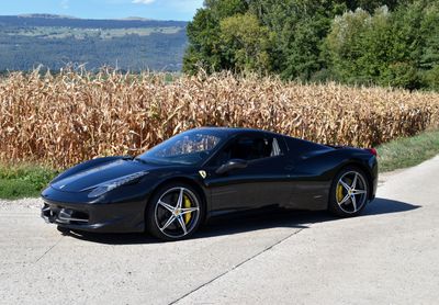 a black sports car that is parked on the side of the road
