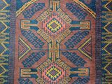 a blue and red rug with a design on it