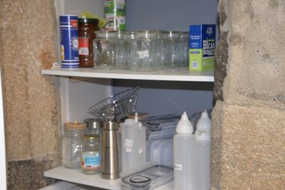 a shelf that has many bottles and containers on it