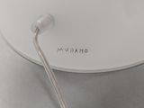 a close up of a white lamp on a table
