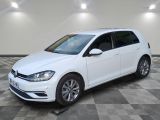 the white volkswagen golf is parked in a room with a checkered floor
