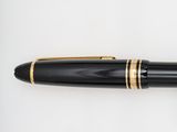 a close up of a pen on a white surface with a white background